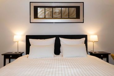 visually stunning main bedroom with hotel king size bed