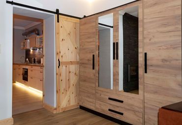 wardrobe in the main bedroom with king size double bed and designer sofa club