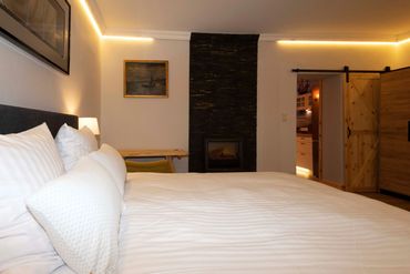 main bedroom with hotel king size bed and wooden desk