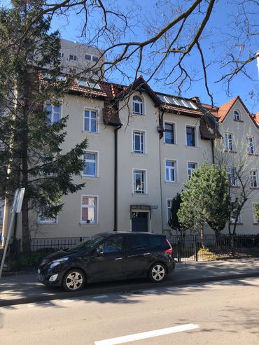 facade of the building. the partment is located on the 1st floor.