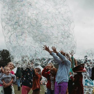 Children playing in big bubbles