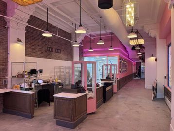 Walnut raised-panel service counters in a quick-service bakery
