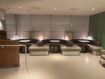 Upholstered banquette run with cherry ledge in a specialty coffee café