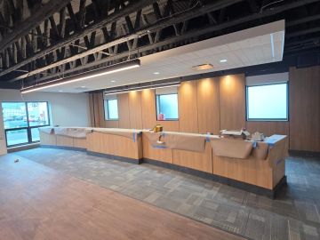 Curved municipal transaction counter with wood wall paneling