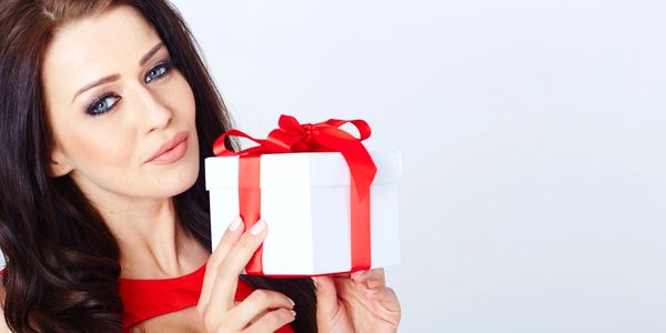 A woman holding a gift box for VIP club members after Botox Restylane Laser Hair Removal