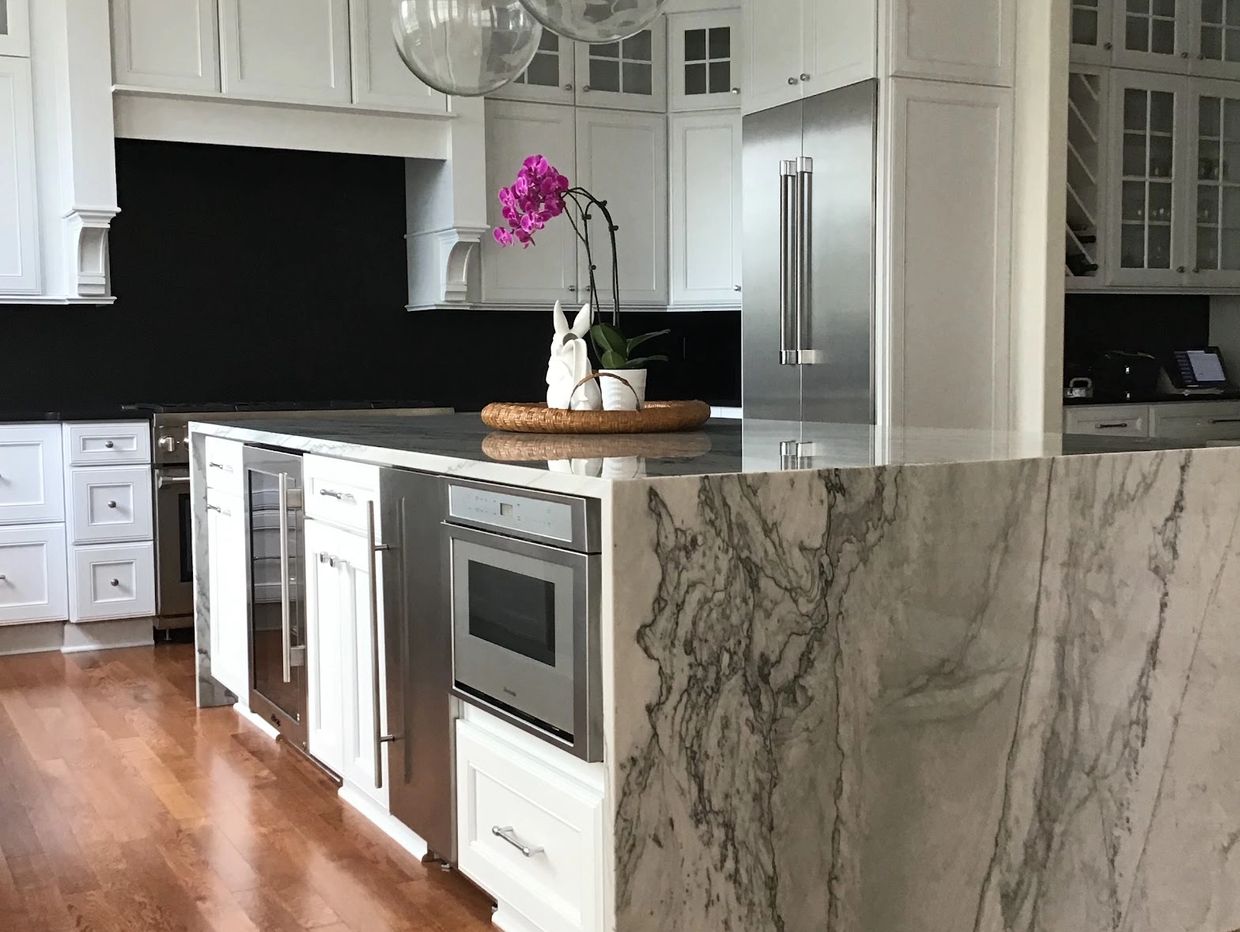 quartz waterfall island from  ultimate granite surfaces - bespoke kitchens and baths