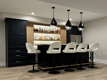 Stunnig Basement Bar renovation with dark blue and warm wood cabinets, quartz countertop island - We