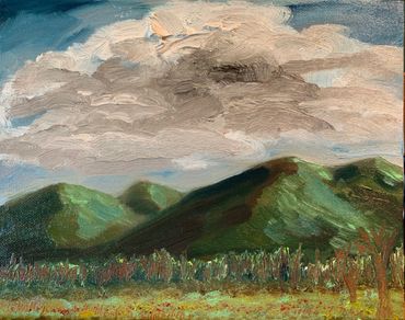 Oil painting of a stormy sky over a mountain range.