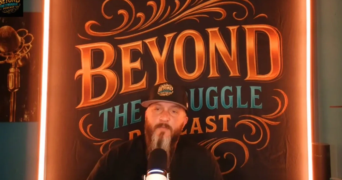Podcast host speaking with 'Beyond The Struggle Podcast' background.