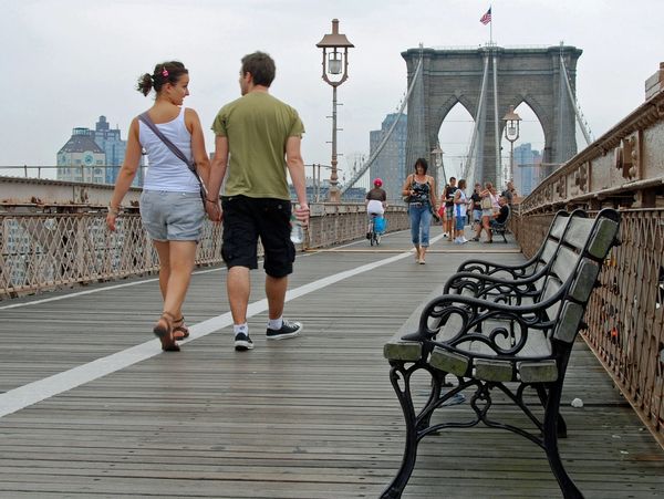 Couple walking over the Brooklyn Bridge. Every activity you engage in will be enhanced by holistic A