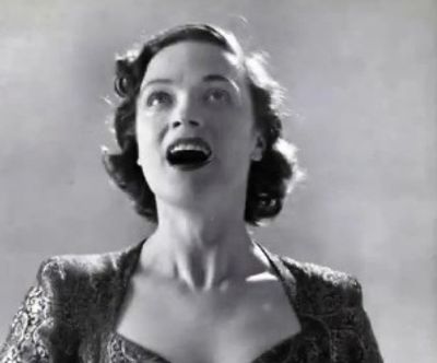 Woman joyfully singing.