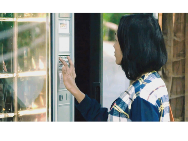 Woman using a vending machine
