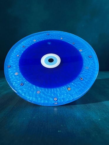 This is a 14" minimalist Evil Eye. A 10" Turkish glass eye with 16 smaller eyes with a blue base.