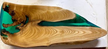 Wood slab with blue resin river in the center, polished surface.