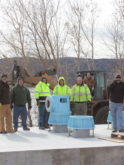 Engineered Water Flow Management Systems And Solutions Group Of Technicians Outside Worksite