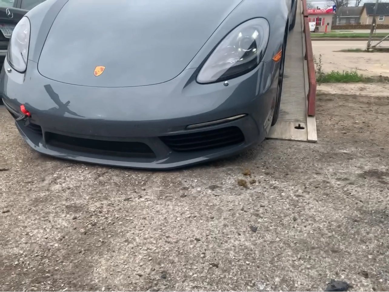 Front view of a gray Porsche vehicle on a ramp.