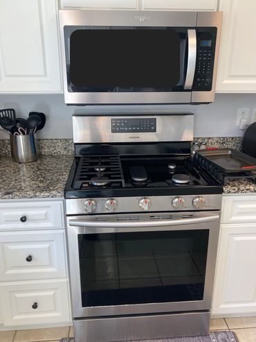 a stainless steel stove and microwave in a kitchen
