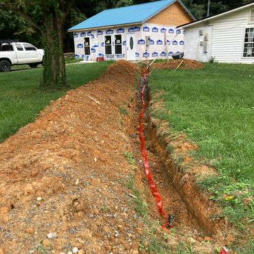 a house under construction with a pile of dirt in front of it