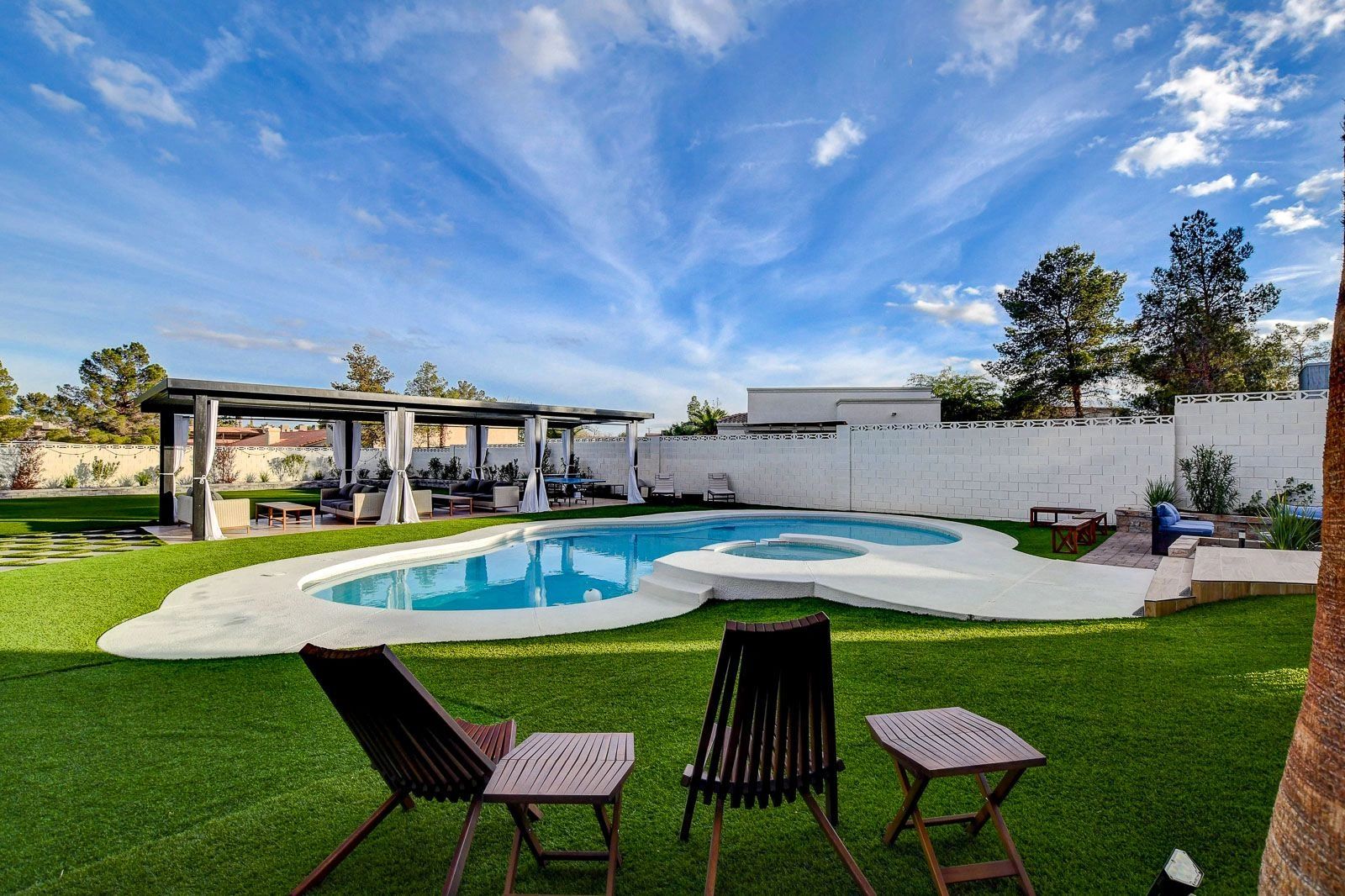 Manicured green lawn with unique pool in Las Vegas at private venue.