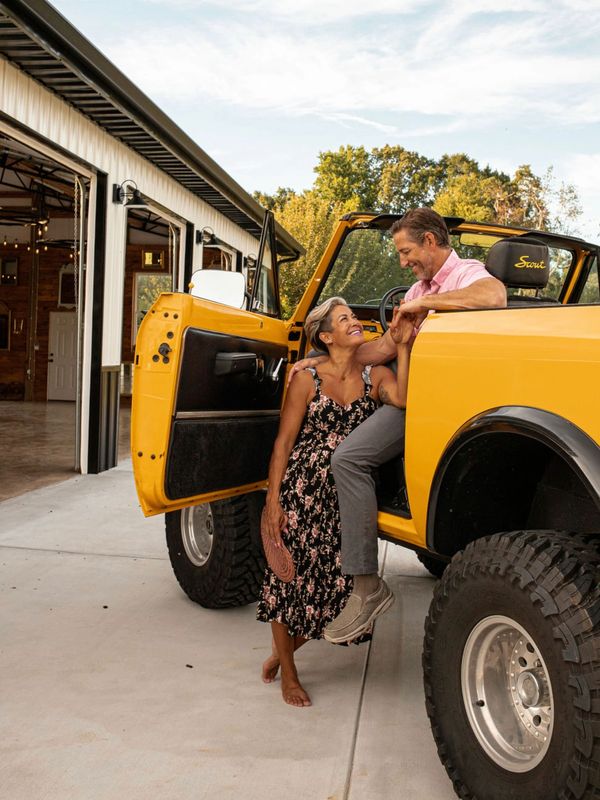 Jeff & Vanessa Moser, owner of Moser Manor Farms, are standing in front of their International Scout