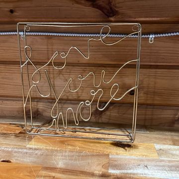 Gold “Love You More” sign