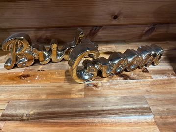 gold bride and groom sign