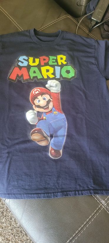 Navy blue t-shirt featuring Super Mario graphic and colorful logo.