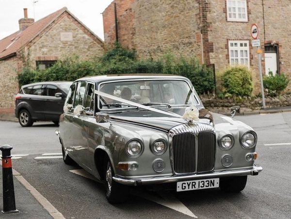 A classic 1974 Jaguar Daimler DS420 with wedding ribbons
