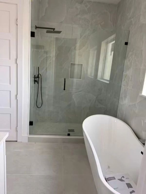 Modern bathroom with a glass shower and freestanding bathtub.