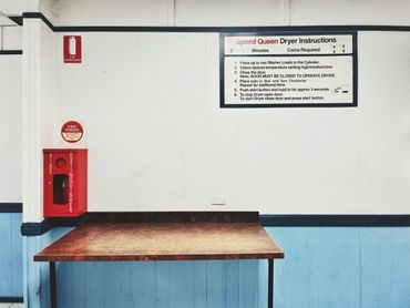 Laundry room corner with drying instructions and fire extinguisher.
