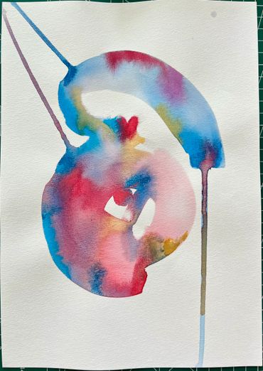 Abstract watercolor painting with vibrant blues, reds, and pinks blending smoothly.