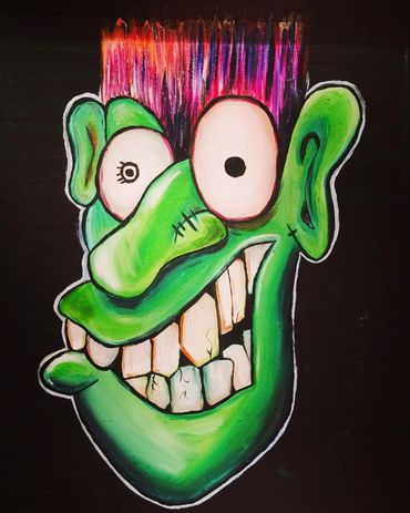 Colorful cartoonish green face with big eyes and spiky hair.