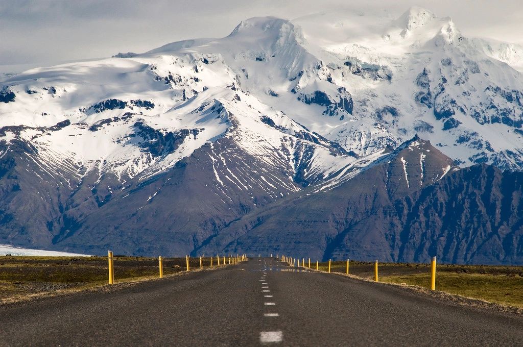 Image of a road leading to a snow covered mountain