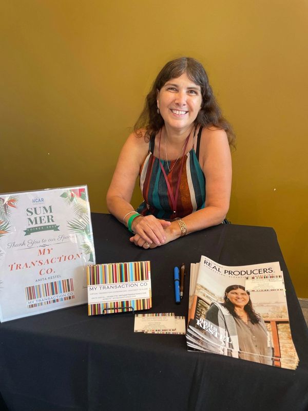 Anita Kestel seated at her sponsor vendor table at HCAR 2022 Summer Soiree