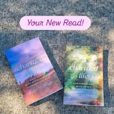 Two books with the title "charmed life" on a textured surface.