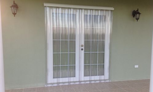 Clear storm panels mounted with track on french doors