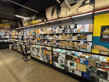 A store counter filled with various boxed electronics and gadgets.