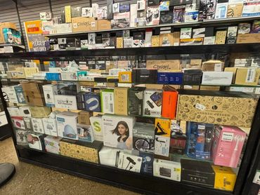 Display case filled with various electronic gadgets and accessories.