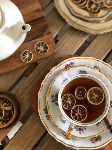 Tea with dried lemon slices in floral china.