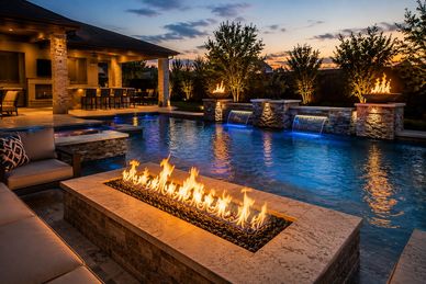 Luxury outdoor pool area with fire features and cozy seating at dusk.
