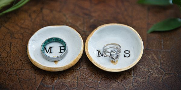 Mr and Mrs wedding rings in two small dishes
