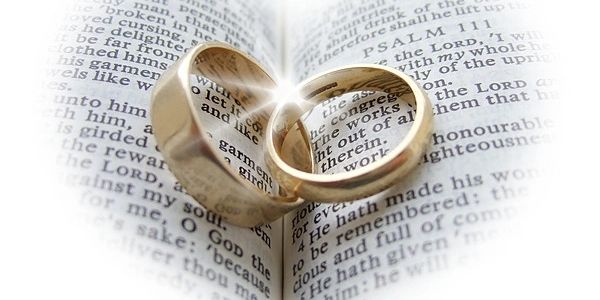Wedding rings on open bible.