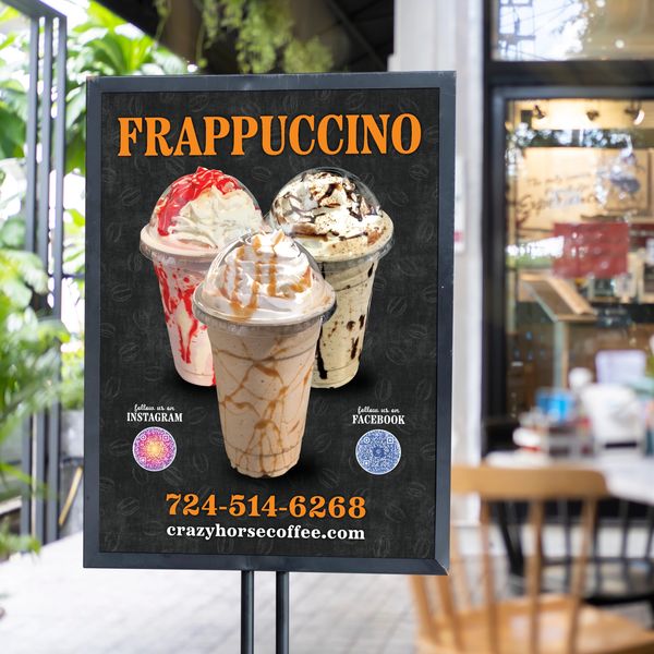 Coffee shop sign advertising frappuccinos with phone number.
