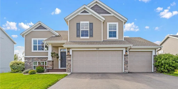 Two-story suburban house with a three-car garage.
