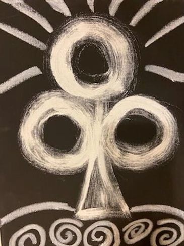 Chalk drawing of a stylized three-looped symbol with radiating lines on black background.