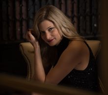 A woman smiling while sitting down