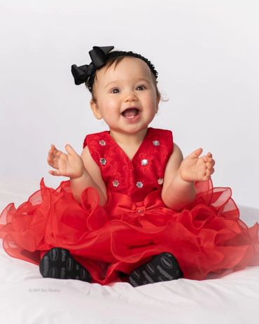 A toddler in her red dress