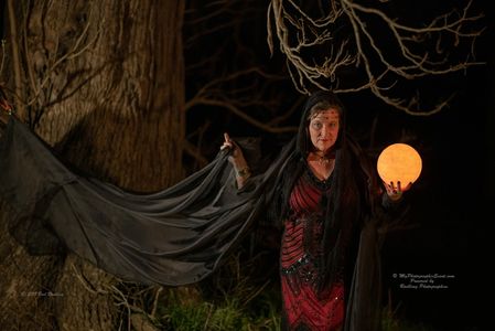 A woman playing as a mystical figure