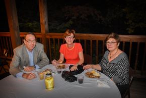 Three people eating at a table