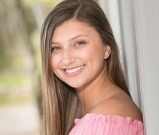 A woman in pink smiling